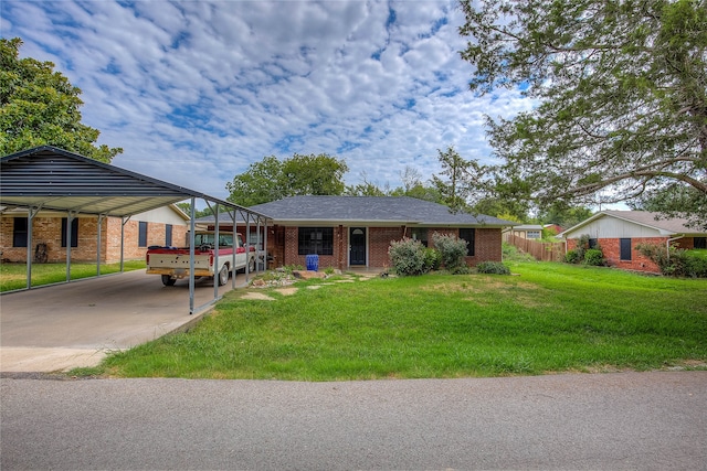 view of front of property featuring a front lawn and a carport