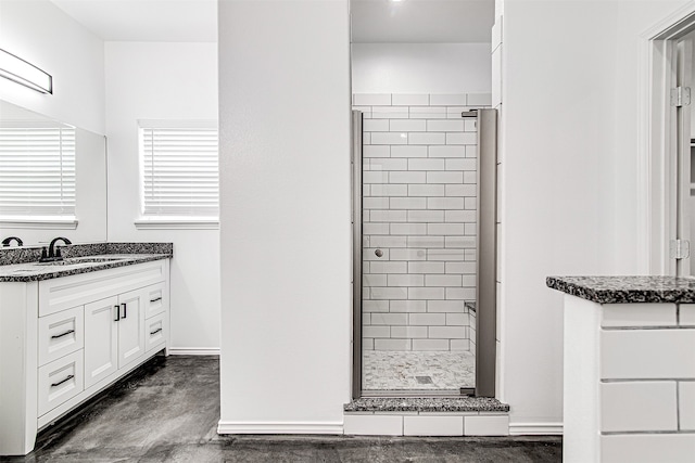 bathroom featuring vanity, concrete flooring, and a shower with door