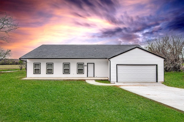 view of front of house featuring a garage and a yard