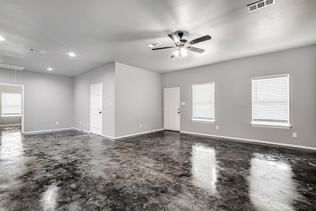 spare room with ceiling fan and a textured ceiling