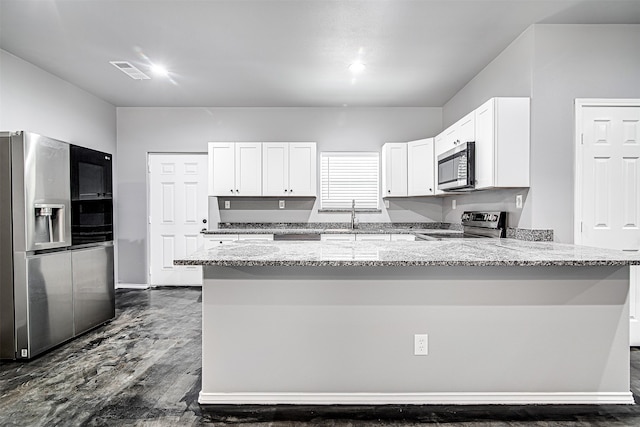 kitchen with kitchen peninsula, appliances with stainless steel finishes, light stone counters, dark wood-type flooring, and white cabinets