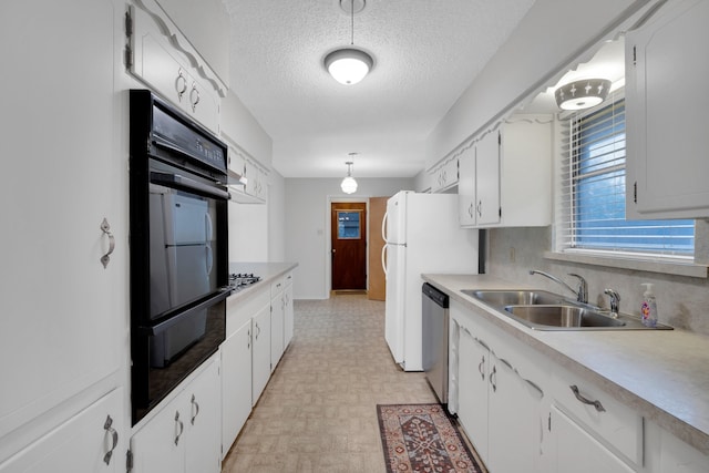 kitchen featuring sink, stainless steel dishwasher, light parquet flooring, a textured ceiling, and white cabinets