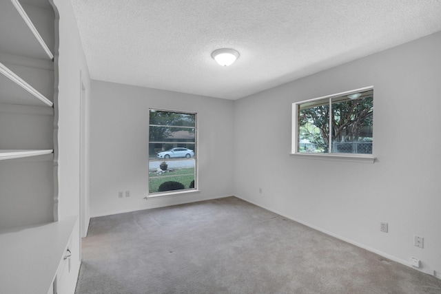 714 Rea Ave, Lancaster, TX 75146 - carpeted empty room with a textured ceiling and baseboards