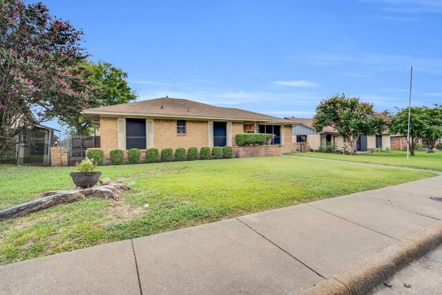 714 Rea Ave, Lancaster, TX 75146 - single story home with fence, roof with shingles, a front yard, and brick siding