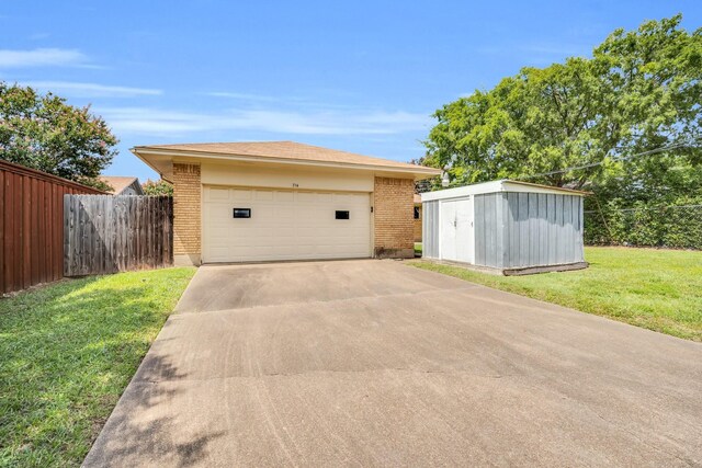 714 Rea Ave, Lancaster, TX 75146 - view of home's exterior featuring a garage, an outdoor structure, a yard, brick siding, and fence
