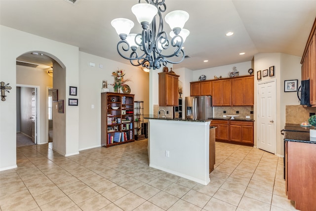 kitchen featuring tasteful backsplash, a notable chandelier, light tile patterned flooring, and stainless steel refrigerator with ice dispenser