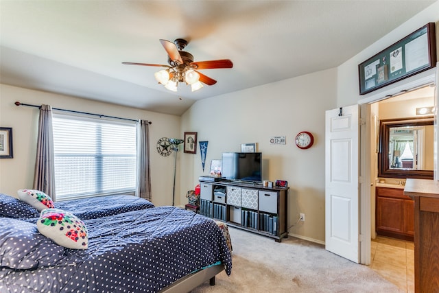 tiled bedroom featuring ceiling fan and ensuite bath