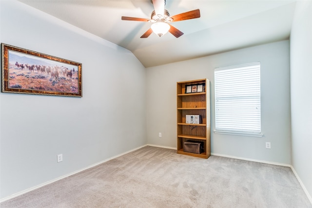 carpeted empty room with ceiling fan and vaulted ceiling