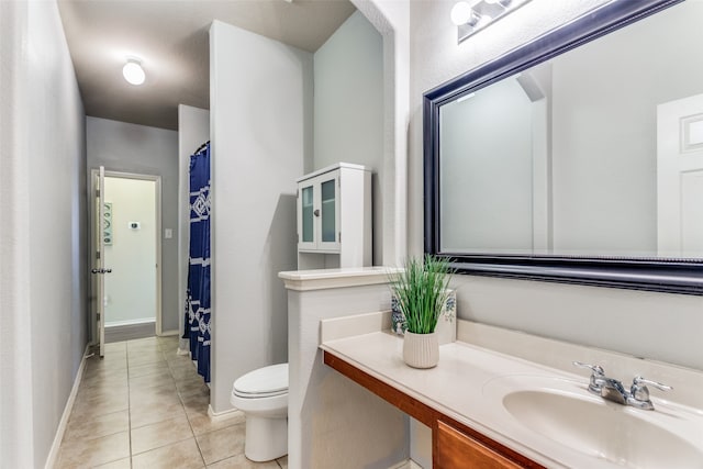 bathroom featuring tile patterned floors, toilet, and vanity