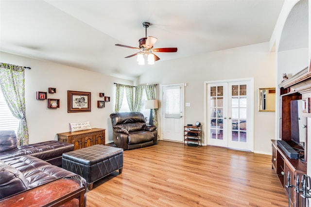 living room with light wood-type flooring, ceiling fan, french doors, and a healthy amount of sunlight