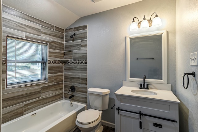 full bathroom featuring vaulted ceiling, vanity, tiled shower / bath, and toilet