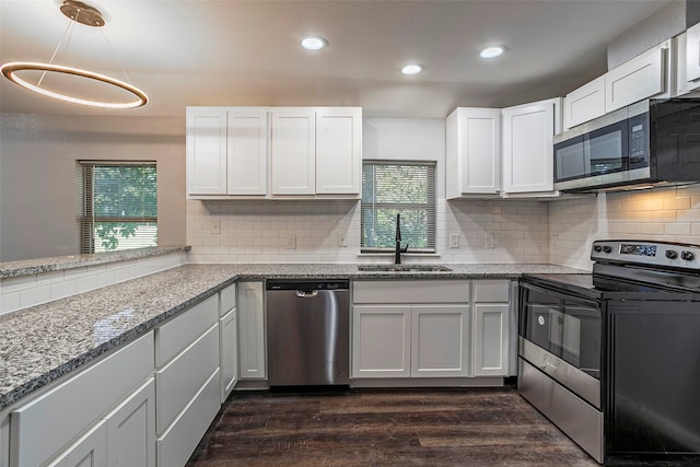 kitchen with stainless steel appliances, decorative backsplash, dark hardwood / wood-style flooring, and a healthy amount of sunlight