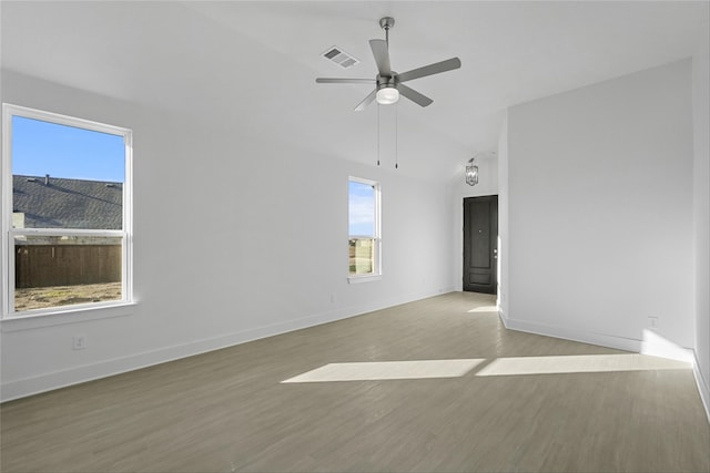 spare room featuring plenty of natural light, ceiling fan, and light hardwood / wood-style flooring