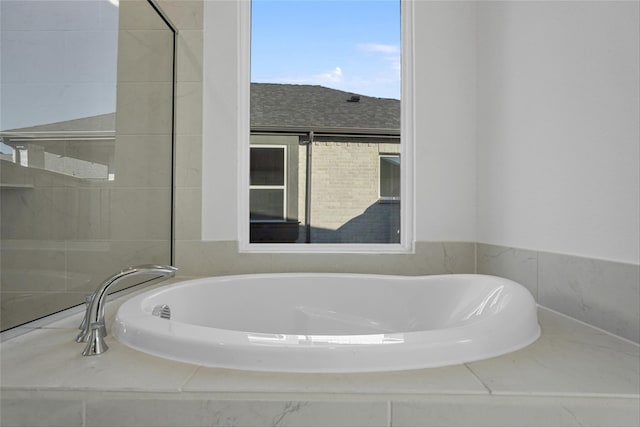 bathroom featuring tiled bath