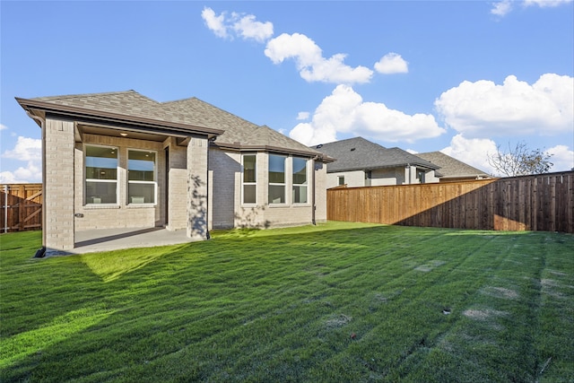 rear view of house with a yard