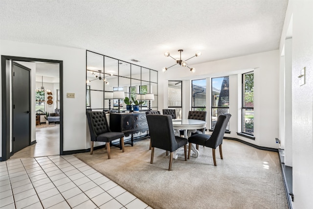 carpeted dining room featuring a textured ceiling and a notable chandelier