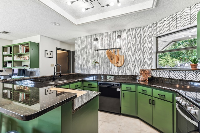 kitchen featuring a textured ceiling, oven, black dishwasher, green cabinets, and sink