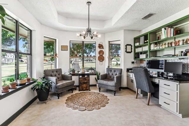 office area featuring a chandelier, a raised ceiling, and a textured ceiling