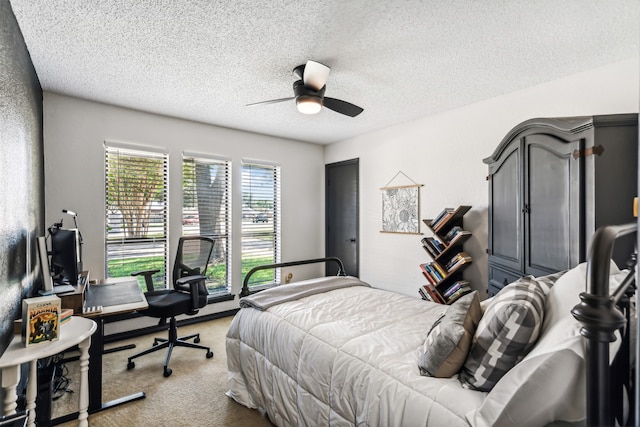 bedroom featuring a textured ceiling, carpet, and ceiling fan