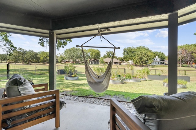 view of patio / terrace with a vegetable garden and fence