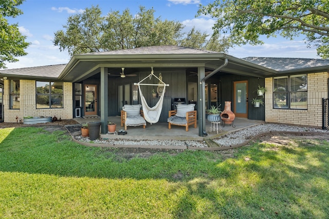 rear view of property featuring a yard and a patio