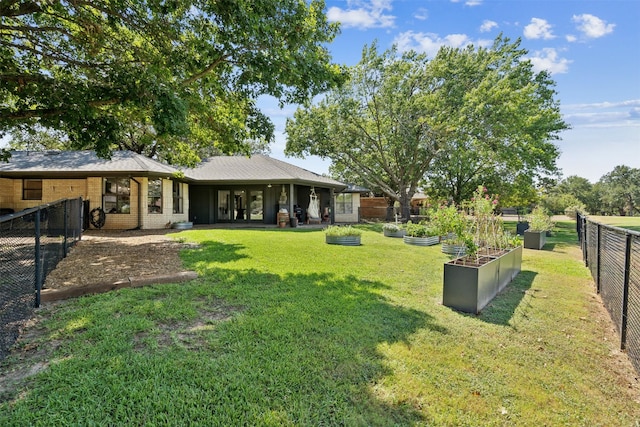 view of yard with a fenced backyard and a garden