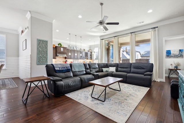 living room featuring crown molding, ceiling fan, and dark wood-type flooring