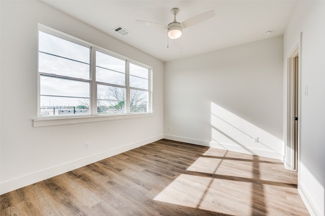 empty room with ceiling fan and wood-type flooring