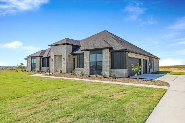 view of front of home featuring a garage and a front lawn