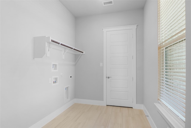 laundry area with light wood-type flooring, hookup for a washing machine, gas dryer hookup, and hookup for an electric dryer