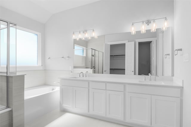 bathroom with lofted ceiling, separate shower and tub, vanity, and a healthy amount of sunlight