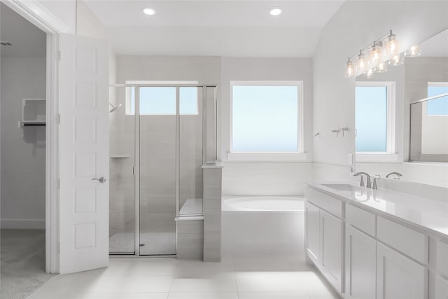 bathroom featuring tile patterned floors, a wealth of natural light, vanity, and independent shower and bath