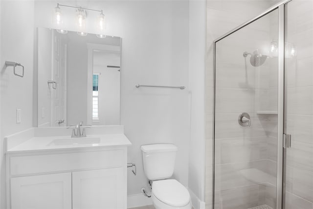 bathroom featuring an enclosed shower, vanity, and toilet