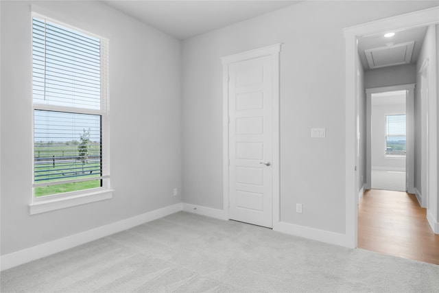 unfurnished bedroom with light colored carpet