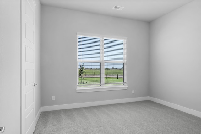 carpeted empty room with plenty of natural light