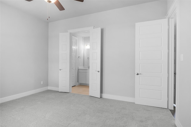 unfurnished bedroom with ceiling fan and light colored carpet