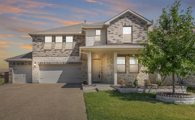 view of front of house featuring a yard and a garage