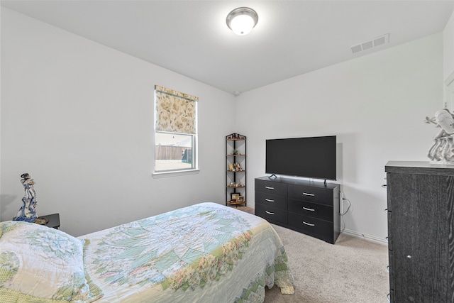 bedroom featuring light carpet