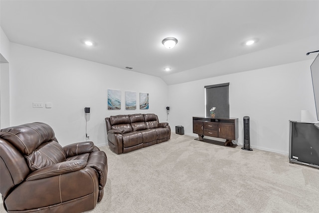 carpeted living room featuring lofted ceiling