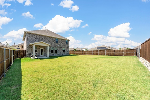 back of property featuring a yard and a patio