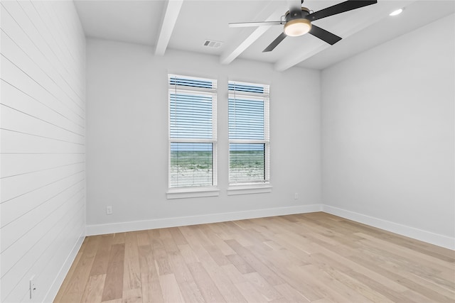 unfurnished room featuring light hardwood / wood-style floors, beam ceiling, and ceiling fan