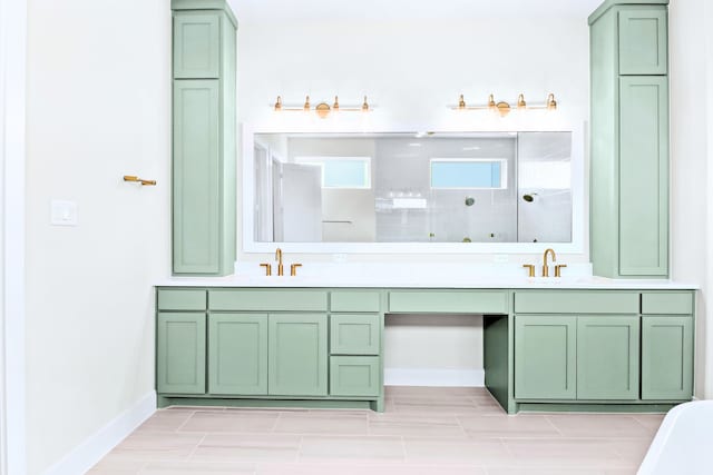 bathroom with a tile shower and vanity