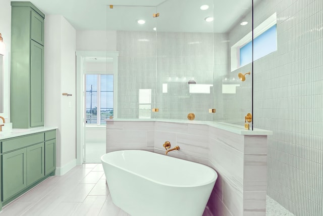 bathroom with vanity, independent shower and bath, and tile walls