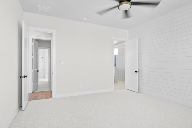 unfurnished bedroom with light colored carpet and ceiling fan