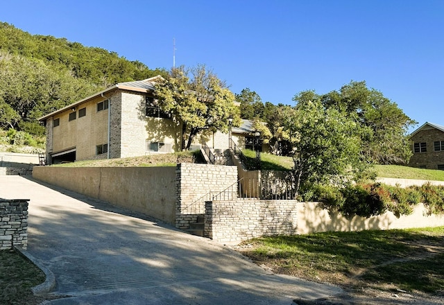 view of side of home featuring fence