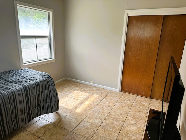 bedroom with multiple windows and light tile patterned floors