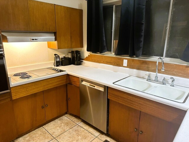 kitchen with light tile patterned flooring, sink, extractor fan, and dishwasher