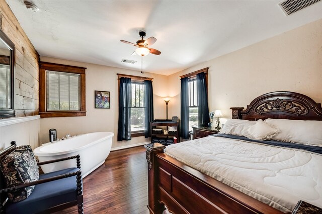 bedroom with ceiling fan, dark wood-type flooring, and visible vents