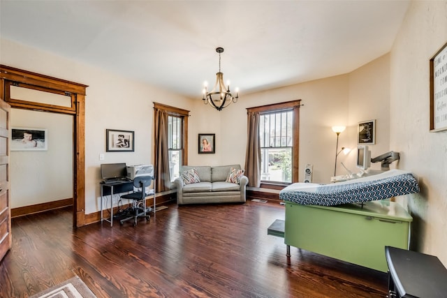 bedroom featuring a notable chandelier, baseboards, and wood finished floors