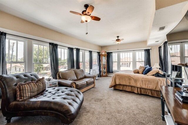 bedroom featuring visible vents, ceiling fan, carpet flooring, and multiple windows